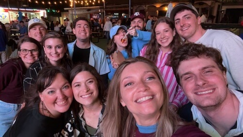 Dr. Dakota Mitchell taking a group selfie with friends at night — Amarillo, TX