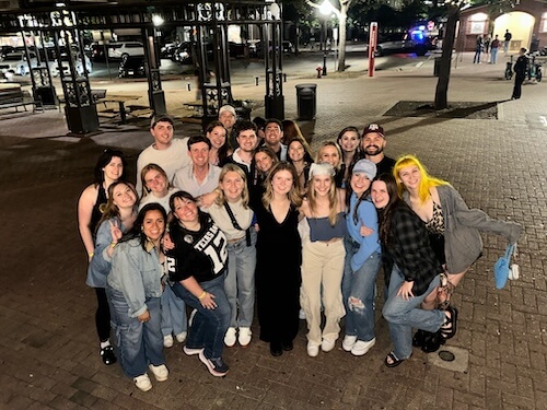 Dr. Dakota Mitchell with a large group of friends outdoors at night — Amarillo, TX