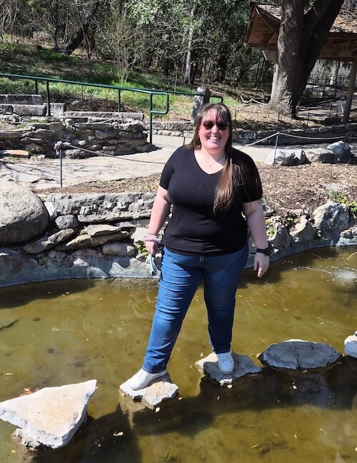 Dr. Dakota Mitchell standing on stepping stones at an outdoor park — Amarillo, TX